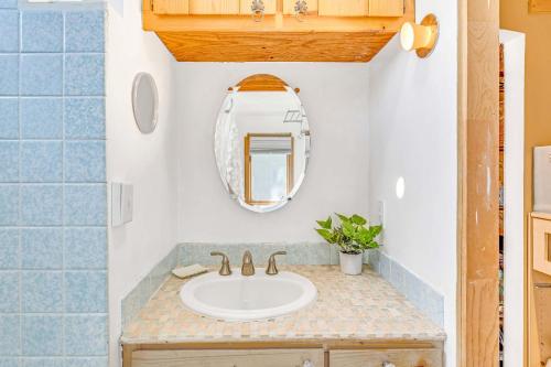 a bathroom with a sink and a mirror at Quaint Carmel - Bungalow Close to Beach in Carmel