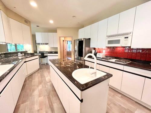 a large white kitchen with a sink in it at Spacious 4 BDR Home in Desirable Abbey Springs in Lake Geneva