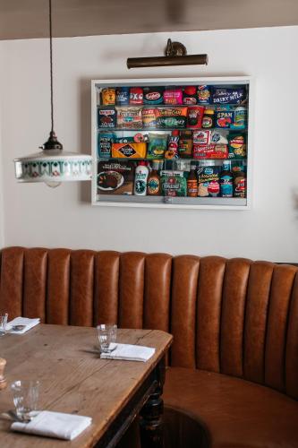 a wooden table in a restaurant with a picture on the wall at Artist Residence Oxfordshire in Oxford