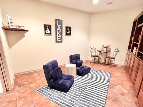 a living room with two blue chairs and a table at Spacious 4 BDR Home in Desirable Abbey Springs in Lake Geneva