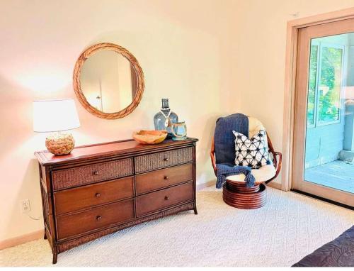 a room with a dresser and a mirror and a chair at Spacious 4 BDR Home in Desirable Abbey Springs in Lake Geneva