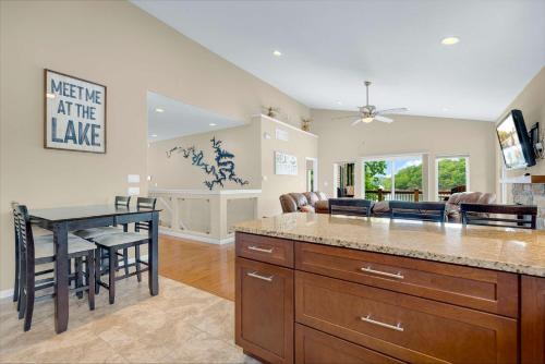 a kitchen and living room with a table and chairs at Trails End Hideaway - Waterfront in Sunrise Beach