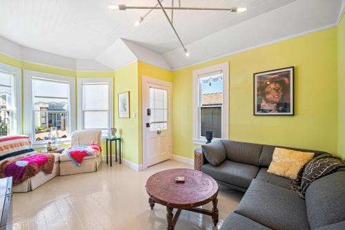 a living room with a couch and a table at Aldrich House - PG Charmer Walk to Lovers Point in Pacific Grove