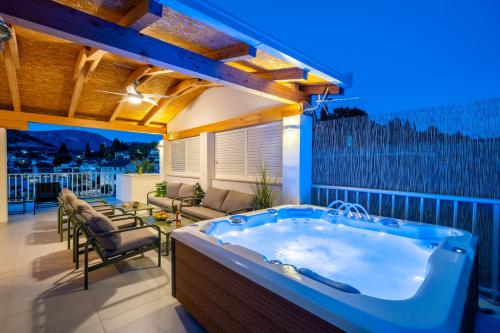 a hot tub on the balcony of a house at Villa Senka in Rogotin