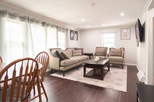 a living room with two couches and a table at Chic Downtown Lake Geneva Apartment - Sleeps 2 in Lake Geneva