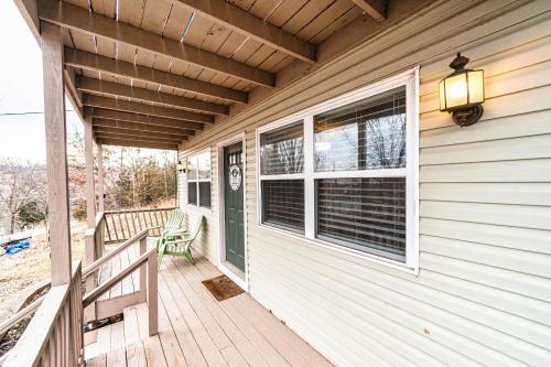 a porch of a house with a bench and a window at Osage Beach Getaway - Lake Views & Pet Friendly in Osage Beach