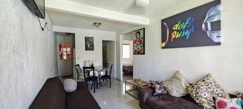 a living room with a couch and a table at Casa con Alberca en Ixtapa Zihuatanejo Internet in Ixtapa