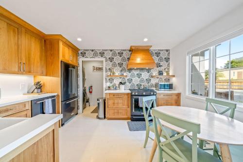 a kitchen with wooden cabinets and a table and chairs at Your Dream Seaside Vacation Charming 2 BDR Home in Seaside