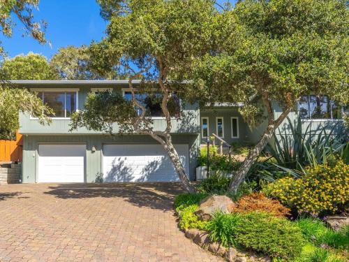 a house with a driveway and a garage at Azure Grove - Pebble Beach Tranquility for a Family of 8 in Pebble Beach
