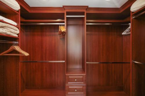 a walk in closet with wood paneling at Poinsettia Palms - Chic & Luxe Patio Near Beach in Corona del Mar