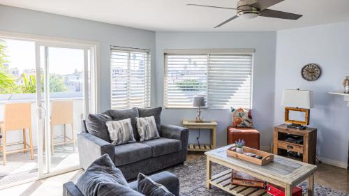 a living room with a couch and a table at Balboa Escape An Iconic Stay in Newport Beach