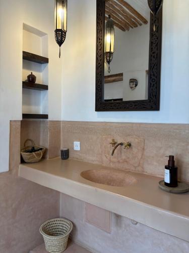 a bathroom with a sink and a mirror at Riad Dar Balthazar in Marrakesh