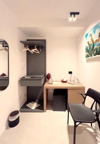 a room with a desk and a chair in a room at Cefalù Luxury Suite in Cefalù