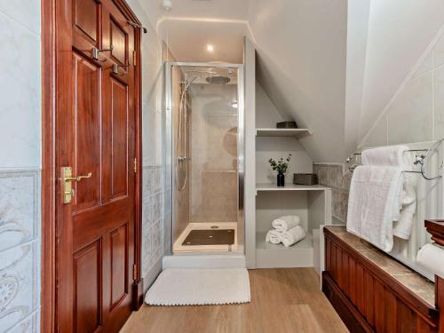 a attic bathroom with a shower and a toilet at 2 Bed in Winterborne Stickland 95140 in Winterborne Stickland