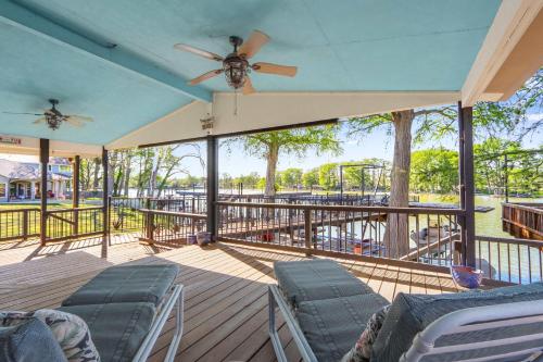 a deck with chairs and a ceiling fan at Amazing Lakefront Escape - A Stunner For Sleeps 14 in New Braunfels