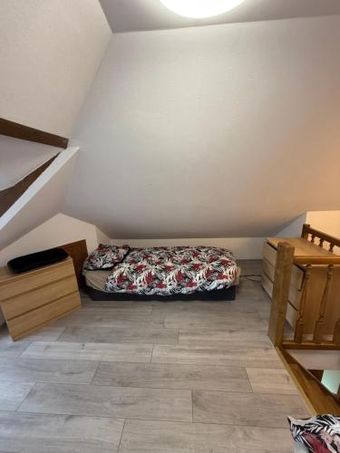 a bedroom with a bed in the corner of a attic at Agroturystka Jaśkowo 