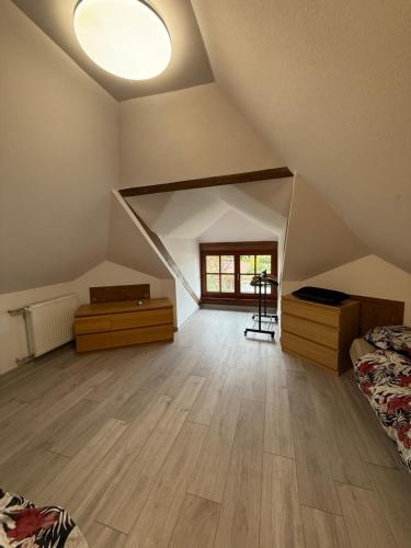 a attic room with two beds and a window at Agroturystka Jaśkowo 