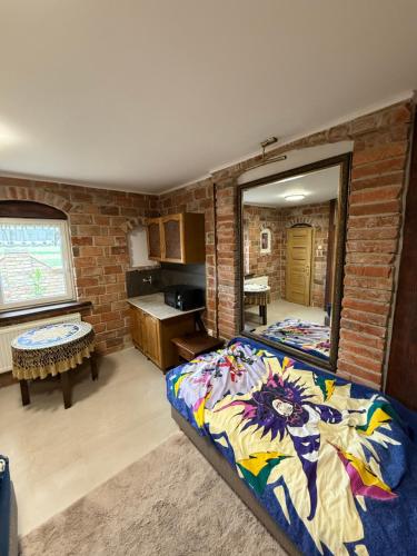 a bedroom with a bed and a mirror in it at Agroturystka Jaśkowo 