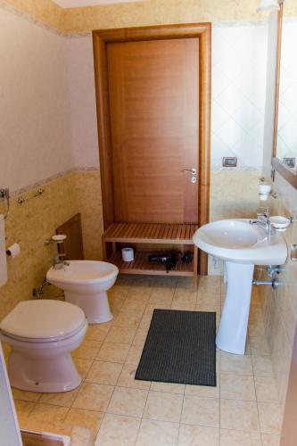 a bathroom with a toilet and a sink and a shower at B&B Ore Liete in Martano
