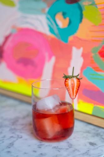 a glass of tea with a strawberry in it at Artist Residence Bristol in Bristol