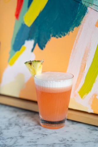 a drink sitting on a table with a slice of pizza at Artist Residence Bristol in Bristol