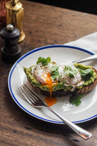 a plate with an egg sandwich on a table at Artist Residence Bristol in Bristol