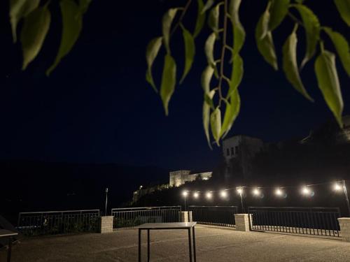 a row of lights on a fence at night at Latifi Guesthouse in Gjirokastër