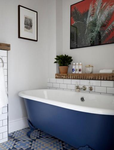 a bathroom with a large blue tub in a room at Artist Residence Bristol in Bristol