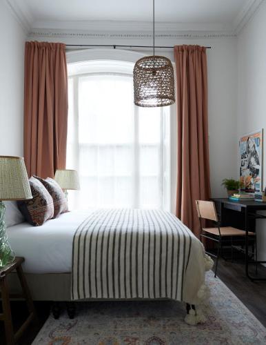 a bedroom with a bed and a window and a desk at Artist Residence Bristol in Bristol