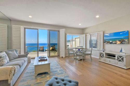 a living room with a couch and a table at Beachfront Sunset in Encinitas