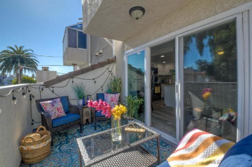 a balcony with a table and chairs on a patio at Silver Surf Getaway in Oceanside