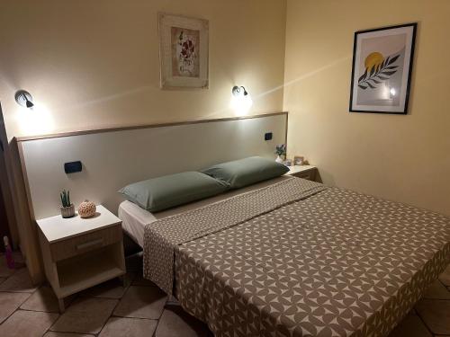 a hotel room with a bed and two night stands at La Piazzetta in Tortoreto Lido