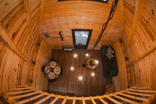 an inside view of a cabin with a clock and stairs at Javorje24 chalets in Žabljak
