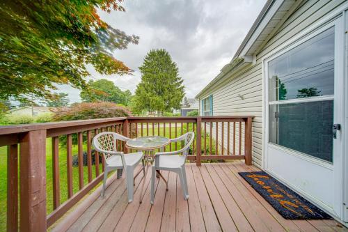 a table and two chairs on a wooden deck at 1 Mi to Lake Access Erie Home with Private Backyard in Erie