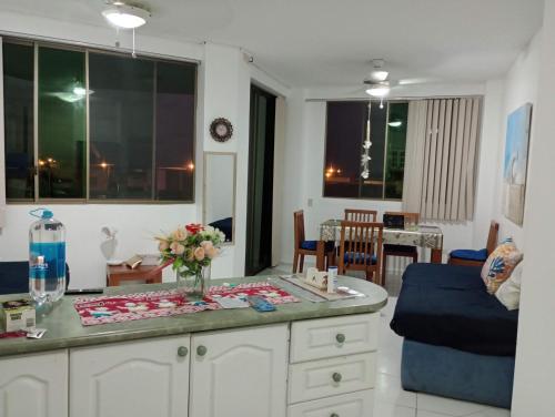 a living room with a table with flowers on it at Playa Costa Azul Tonsupa- Esmeraldas in Volcán Chimborazo