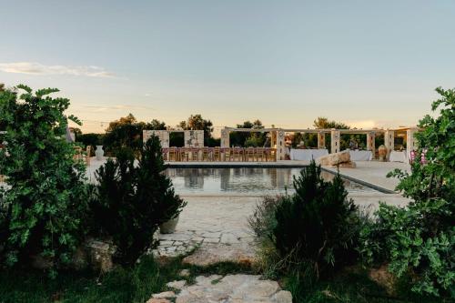a resort with a swimming pool and a building at Masseria della Piana in Villanova di Ostuni