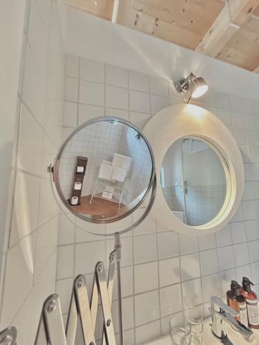 a mirror on a wall above a bathroom sink at Cottage Gols in Gols