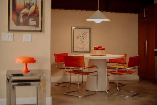 a table with chairs and a table with a cake on it at Mane & Saddle Loft in Los Angeles