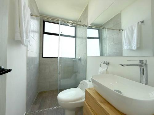 a white bathroom with a sink and a toilet at Nueva Finca, Piscina, Jacuzzi Y Fire Pit in Alcalá