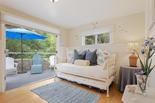 a bedroom with a bed and a patio with an umbrella at Seashore Retreat by Paradise Retreats in Montecito