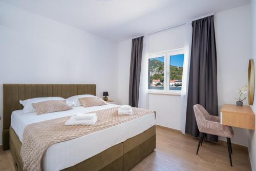 a bedroom with a large bed and a window at Villa Senka in Rogotin