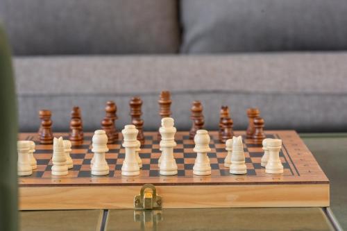 a wooden chess set on a wooden chess board at Villa Senka in Rogotin