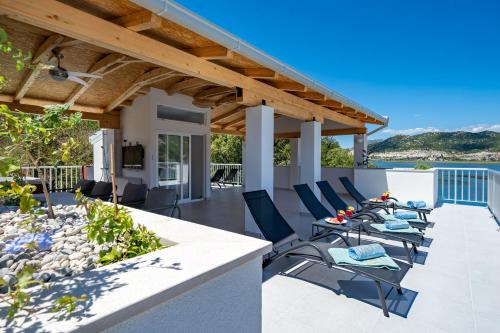 a patio with chairs and a table on a house at Villa Senka in Rogotin