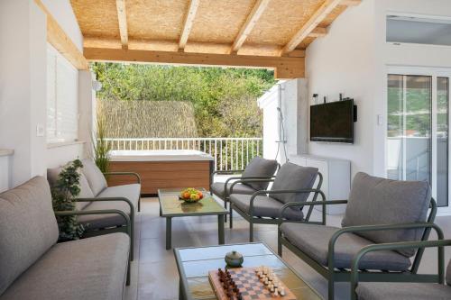 a living room with chairs and a chessboard on a porch at Villa Senka in Rogotin