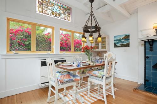 a dining room with a table and chairs at Seashore Retreat by Paradise Retreats in Montecito
