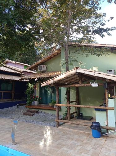 a house with a pool in front of it at Pousada Cigarras da Serra in Serra do Cipo