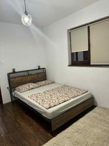 a bedroom with a bed in a room with a window at Cottage Arinda in Jajce