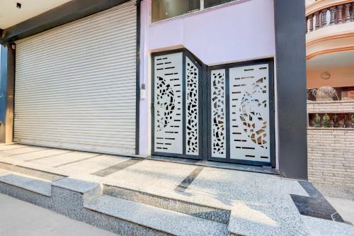 a pair of garage doors on a building at Super Hotel O Sadar Bazar Gurgaon in Gurgaon