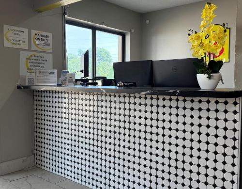 a restaurant counter with a white and black checkered counter at Super 8 by Wyndham Evansville East in Evansville