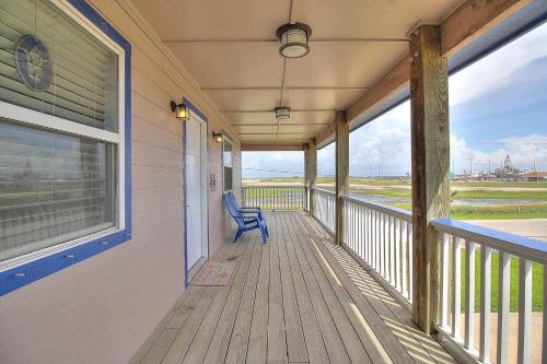 a porch of a house with a blue chair on it at Spacious & Pet Friendly - Game Room Sleeps 10 in Port Aransas
